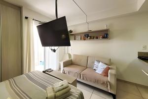 a living room with a bed and a couch at Studio Top Life: Garagem | Wifi | Ar-condicionado NA1002 in Juiz de Fora