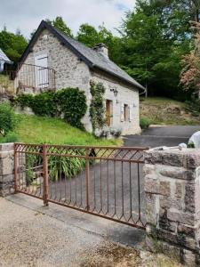 a gate in front of a stone house at Gîte de France à Chaveroche 2 épis - Gîte de France 2 personnes 664 