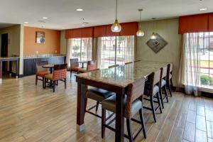 a kitchen and dining room with a large table and chairs at Motel 6-Arlington, TX in Arlington