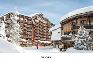 a person walking in the snow in front of a hotel at Résidence Quartier Falaise - maeva Home - Appartement 2 pièces 4 personnes Sélection MAE-2593 in Avoriaz +11 photos