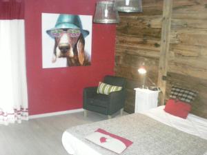 a bedroom with a painting of a dog wearing a hat at Chalet belle vue montagne proche Valmorel 86009 in Valmorel