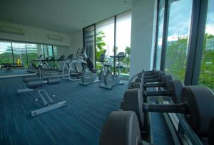 a gym with rows of tread machines in a building at Baan Im Em by little dragon in Hua Hin