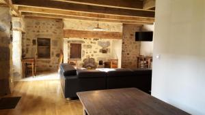 a living room with a couch and a table at Gîte de France Maison raymond 3 épis - Gîte de France 12 personnes MAE-9804 in Saint-Angel