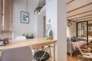 a room with a table and chairs and a couch at Shanghai Hills&XING 1883 Homestay in Shanghai