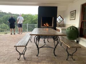 two men standing on a balcony with a fireplace at Heilfontein Country Escape in Hartebeest Rivier +15 photos