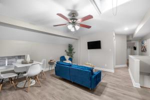 a living room with a blue couch and a ceiling fan at Univ City Drexel 3 Bdrm Lovely Unit in Philadelphia