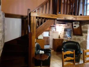 a living room with two chairs and a staircase at Gîte de France à Saint-Cirgues-la-Loutre 3 épis - Gîte de France 2 personnes MAE-0054 in Saint-Cirgues-la-Loutre