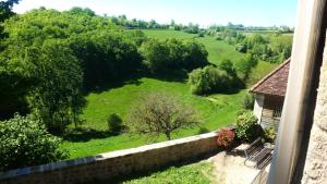 a view of a green field from a window at Gîte de France à Curemonte 2 épis - Gîte de France 4 personnes MAE-0004 in Curemonte