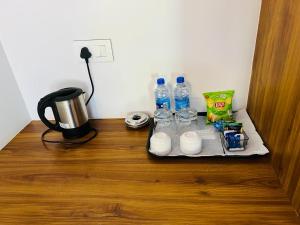 a table with bottles of water and cups on it at Shree Kalya Resort- Chikmagalur in Chikmagalūr
