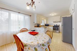 a kitchen with a table and chairs and a refrigerator at Upstate Memories in Rochester