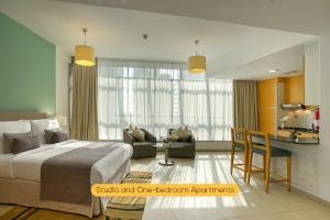 a hotel room with a bed and a kitchen at Grand Heights Hotel Apartments in Dubai