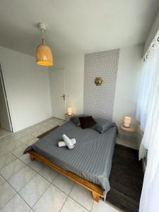 a bedroom with a large bed with two night stands at Résidence Neptune - 2 Pièces pour 4 Personnes 374 in Aix-les-Bains