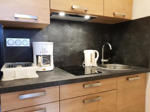 a kitchen with a coffee maker and a sink at Résidence Les Charmettes - Studio pour 3 Personnes 38 in Arc 1600