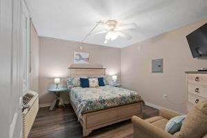 a bedroom with a bed and a ceiling fan at Blue Mist Villas Unit 102 - Oceanfront Ground Floor Condo in Cherry Grove in Myrtle Beach