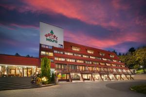 a building with a sign on the side of it at Room in BB - Hotel Moura Double Room n5165 in Borovets