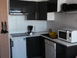 a kitchen with a white refrigerator and a microwave at Résidence Rond-Point-pistes I - Studio pour 6 Personnes 044 in Orcières