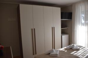 a bedroom with a large white wardrobe and a bed at Rooms Jelka in Dubrovnik