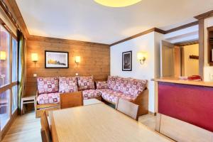 a living room with a couch and a table at Quartier La Forêt - maeva Home - Appartement 3 pièces 6 personnes Sélection MAE-7299 in Valmorel