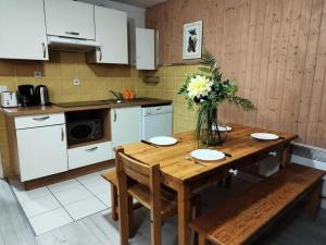 a kitchen with a wooden table with a vase of flowers at Résidence Rond-Point-pistes I - 3 Pièces pour 8 Personnes 224 in Orcières