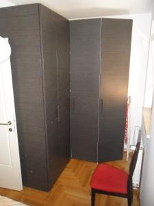 a large black closet with a red chair in a room at Apartment Lela in Pula
