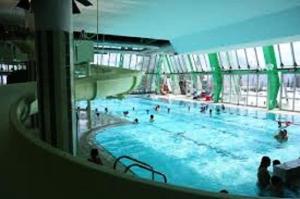 a large swimming pool in a building with people in it at Résidence Rond-point-pistes I - Studio pour 6 Personnes 271 in Orcières