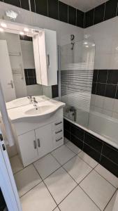 a white bathroom with a sink and a shower at Résidence Rond-point-pistes I - Studio pour 6 Personnes 281 in Orcières