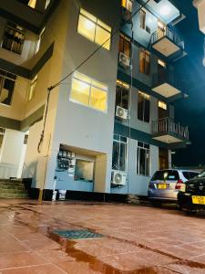 a building with a car parked in front of it at Pishon Home in Dar es Salaam