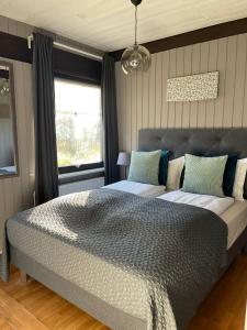 a bedroom with a large bed and a window at Haukaberg House in Höfn