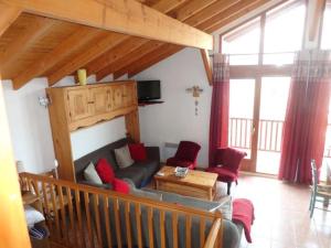 a living room with a couch and red chairs at Beau chalet au départ des pistes 108077 in Aime-La Plagne