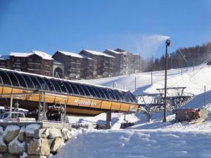 a snow covered ski slope with a ski resort at Beau chalet au départ des pistes 108077 in Aime-La Plagne