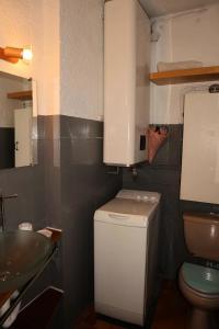 a small bathroom with a sink and a toilet at Résidence LA SEILLE - Studio pour 4 Personnes 974 in Les Orres