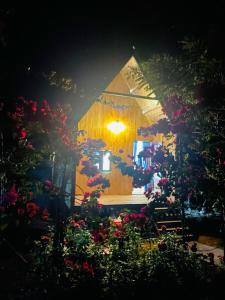 a house with flowers in front of it at night at Phú Cường Tà Đùng Farmstay in Biđong
