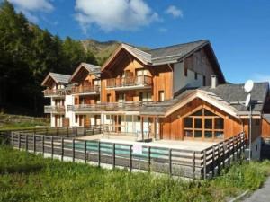 a large house with a pool in front of it at RESIDENCE LA COMBE D OR - 2 Pièces pour 4 Personnes 324 in Les Orres