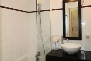 a bathroom with a sink and a shower with a mirror at RESIDENCE LA COMBE D OR - 2 Pièces pour 4 Personnes 324 in Les Orres