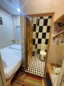 a small bathroom with a bed and a toilet at Winny Hotel Ninh Kieu Quay in Can Tho