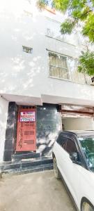 a white car parked in front of a building at Family Homes in - Dwarka sec 8 Near Yashobhoomi in New Delhi