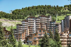 a large apartment building on the side of a mountain at Résidence Arietis - Atria-Crozats - maeva Home - Appartement 2 Pièces 5 Per 29 in Morzine