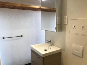biała łazienka z umywalką i szafką w obiekcie Résidence Cascade - Appartement 3 pièces 7 personnes à Arc 1600 ski aux pieds et proche des commerces MAE-2014 w mieście Arc 1600