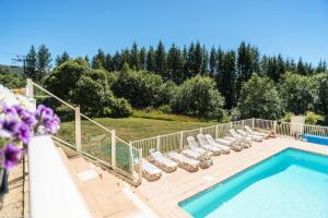 a patio with chairs and a swimming pool at Résidence Les Bergers - maeva Home - Studio Sélection (6 personnes) 38 in LʼHuez