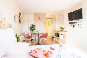 a bedroom with a bed and a table and chairs at Parking - Le Lotus - Tram in Strasbourg