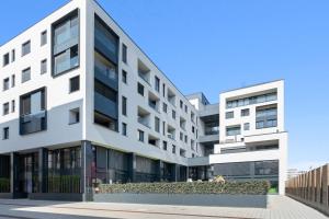 an exterior view of a white building at Chic 3BR Penthouse with Balcony and Smart TV in Esch-sur-Alzette