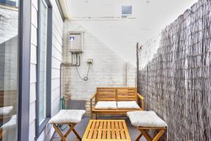 a pair of benches sitting on a balcony at Charming 2 Bedroom House Surry Hills in Sydney