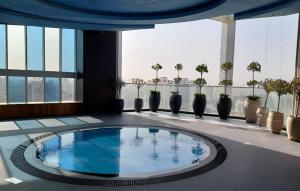 a swimming pool in the middle of a building at Spacious, Economical Apt Near Miralcz Garden in Dubai