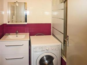 a small bathroom with a washing machine and a sink at Résidence Les Carlines - Studio pour 4 Personnes 234 in Le Mélézet