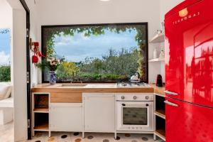 A kitchen or kitchenette at TRULLO SANTA PAZIENZA 6&3, Emma Villas