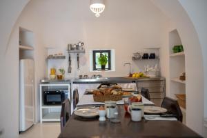 A kitchen or kitchenette at TRULLO SANTA PAZIENZA 6&3, Emma Villas