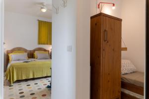 A bed or beds in a room at TRULLO SANTA PAZIENZA 6&3, Emma Villas