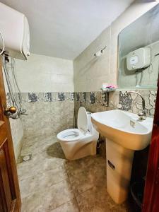 a bathroom with a toilet and a sink at Islamabad guest house in Islamabad