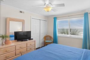 默特尔比奇A Summer Place Unit B8 is Small Dog Friendly and oceanfront in Cherry Grove的一间卧室配有一张床、一台电视和一面镜子 更多18张照片