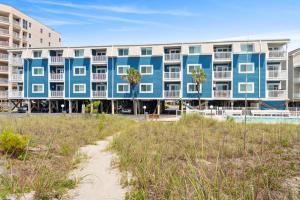 默特尔比奇A Summer Place Unit B8 is Small Dog Friendly and oceanfront in Cherry Grove的海滩上的蓝色和白色公寓大楼